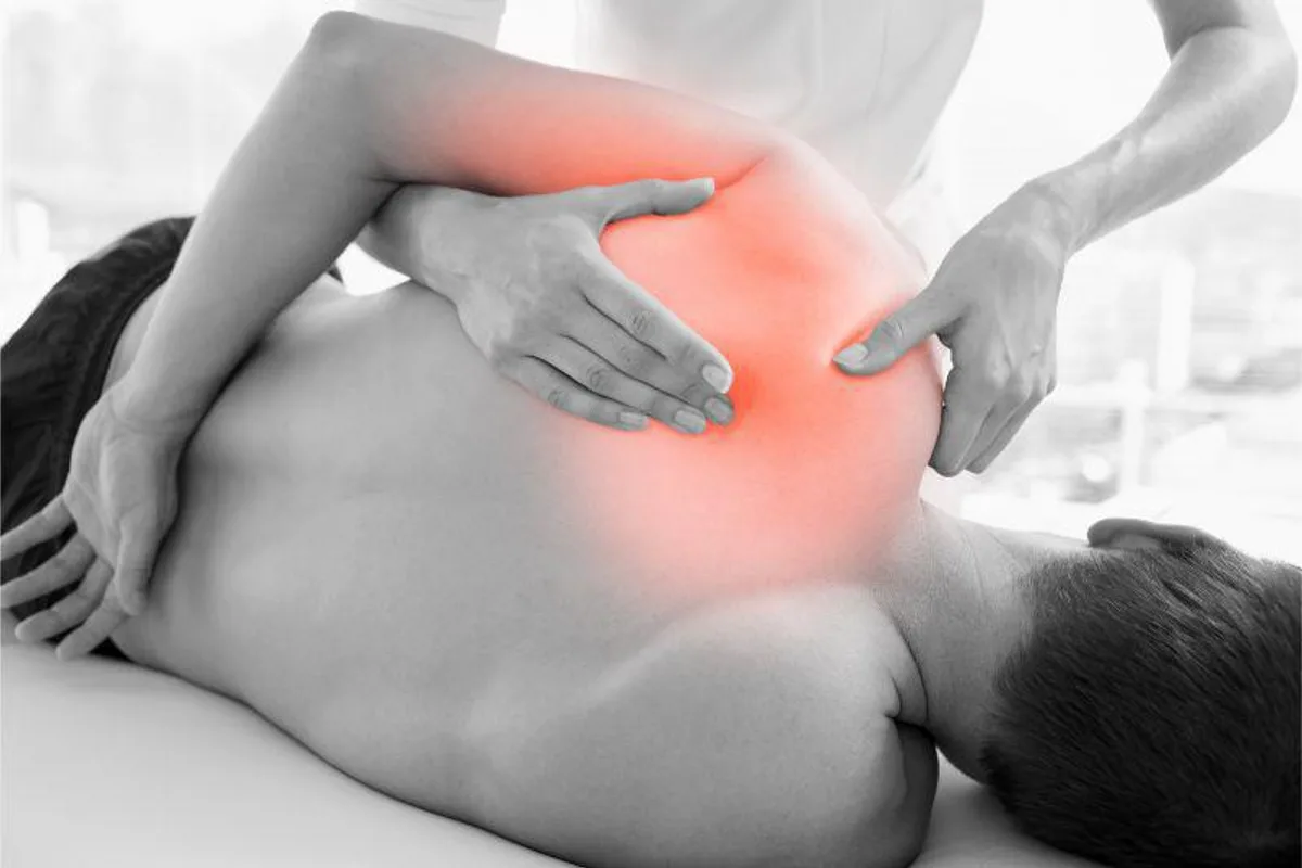 A therapist treating a patient's shoulder at Midtown East Physical Therapy in New York, NY